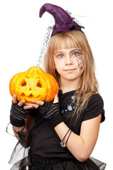 Little girl wearing witch halloween costume holding pumpkin isolated