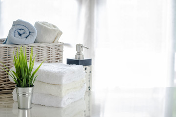 white towels on white table with copy space on bright room background