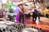 The disco, Banquet, people blurred background dancing. Dj panel