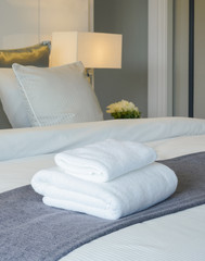 Clean towel on bed in modern interior bedroom