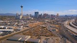 Aerial view of Las Vegas strip in Nevada, USA. View of the Stratosphere hotel and other popular buildings as well as highway and roads through the city.