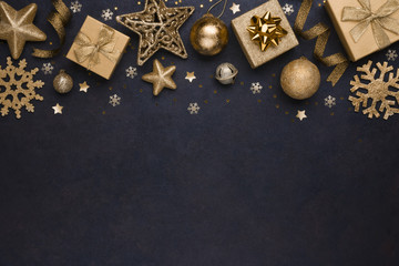 Golden snowflakes, gifts, christmas balls and stars on dark background