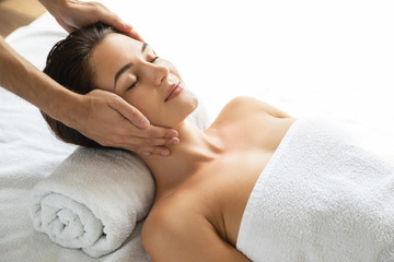 Young and beautiful woman during facial massage session