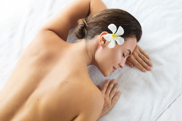 Woman is lying and relaxing after massage session