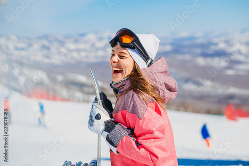 cheerful woman snowboarder laughs © Alyona
