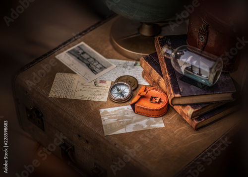Old letters and compass isolated on vintage suitcase © marina
