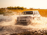 Off-road car fording water on safari wild drive in Chobe National Park, Botswana, Africa