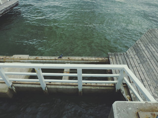 Broken wooden pier on cloudy day