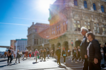 Crowd of anonymous people walking on busy city street