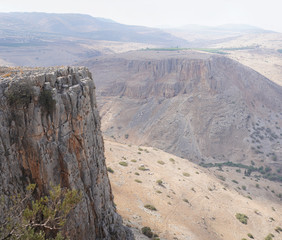 Mount Arbel vertical cliff towering magnificently Golan Heights in Upper Galilee and near Tiberias in Israel.  Nature reserve and national park views 