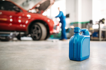 Oil canister on the floor in car service