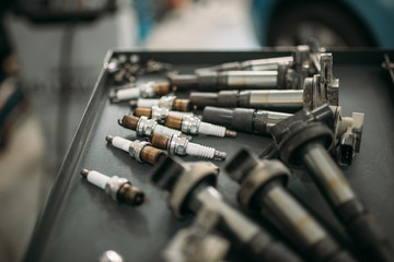 Car spark plugs and wires on the table closeup