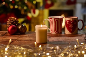 Christmas still life with candle and fireplace