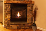 Stone fireplace with flame to warm hearts and home.