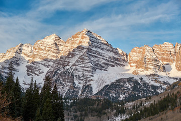 Maroon Bells mountains in snow at sunrise