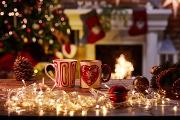 Christmas still life with mugs and fireplace