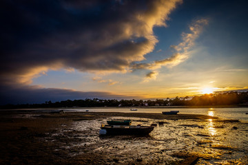 Boat at low tide sunset