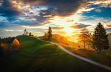 Jamnik, Slovenia - Aerial view over the church of St. Primoz in Slovenia near Jamnik with beautiful clouds and Julian Alps at background.