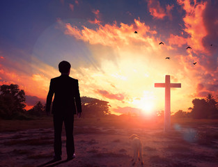 Thanksgiving concept: a businessman standing in front of the cross