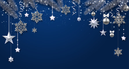 Blue shiny festive background with fir branches and Christmas decorations.