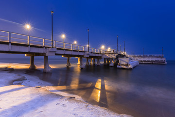 Snowy night at the Baltic Sea pier in Gdansk, Poland