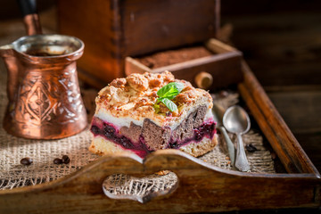 Sweet cherry pie with pot boiled coffee on wooden tray