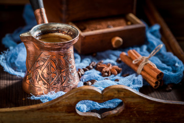 Closeup of aromatic coffee, old grinder and pot boiled coffee