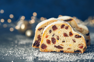 Christmas stollen on dark blue festive background with Xmas lights