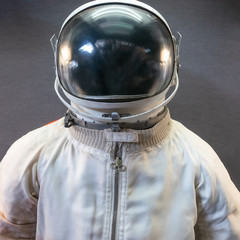 White astronaut or spaceman suit and helmet on grey background