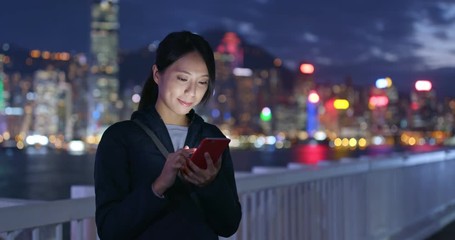 Woman use of cellphone in Hong Kong at night