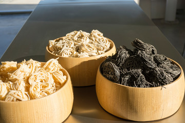 Wooden bowls  with tagliatelle nests