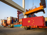 Chinese container with the flag of the People's Republic of China in the port. The concept of Chinese import and export.3D render