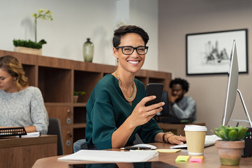 Stylish business woman using smartphone