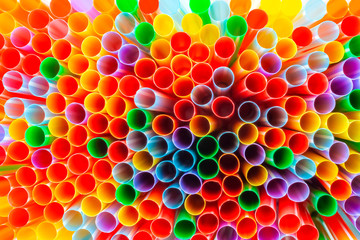 Full frame of a bunch of many plastic drinking straws seen from the top view creating a colorful background