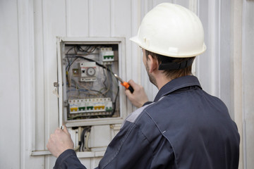 electrician working on electric panel 