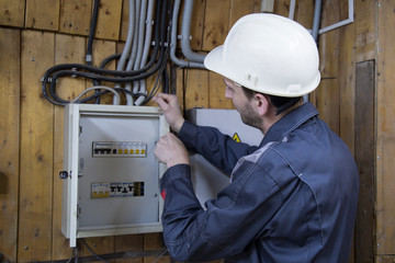 electrician working on electric panel 