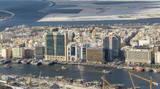 DUBAI - DECEMBER 2016: Buildings along Dubai Creek on a sunny day. Dubai is the major city of United Arab Emirates