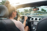 Young woman driving convertible car