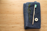 eco natural bamboo toothbrushes and biodegradable silk dental floss on the black towel, sustainable lifestyle concept. zero waste home. bathroom essentials, plastic free items