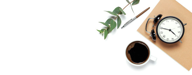Flat lay cup of black coffee, black alarm clock, notebook, diary, eucalyptus on white background top view copy space. Minimalistic food concept, Feminine desk workspace, time to work coffee background