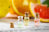 citrus essential oil bottles on fruit background