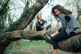 Young couple sitting on a tree in the park