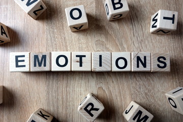 Emotions word from wooden blocks on desk