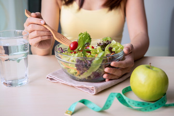 Young woman eating homemade healthy salad at home, Healthy lifestyle, diet concept