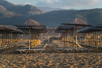 Bamboo, reed, straw beach umbrellas on the beach Falasarne, Greece, Crete