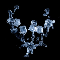 Ice cubes with water splashes on black background