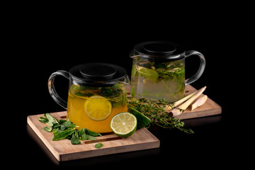 tea in a teapot with lime, mint and thyme