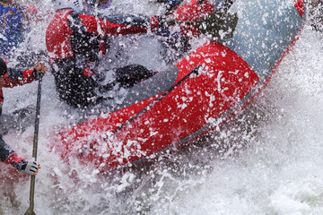 Brave people travel by raffting on a mountain river