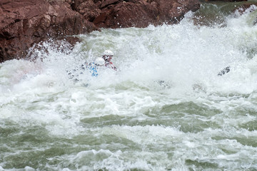 Brave people travel by raffting on a mountain river