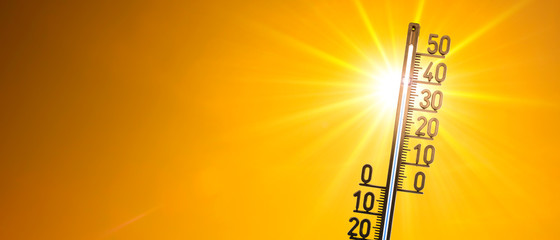 Hot summer or heat wave background, bright sun with thermometer